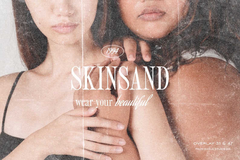 May include: Two women with brown hair are embracing. The woman in the front is wearing a black tank top. The woman in the back is wearing a white tank top. The text "SKINSAND wear your beautiful" is superimposed on the image. The text "1994" is in a circle above the text "SKINSAND". The text "OVERLAY 31 & 47 FROM DARLA STUDIO CO." is at the bottom of the image.