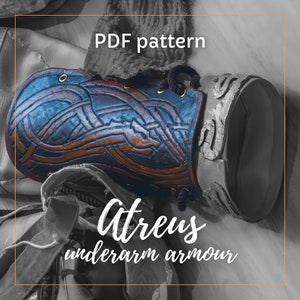 May include: A PDF pattern for Atreus forearm armor. The armor is made of leather and has a blue and brown color scheme with intricate designs. The pattern is for crafting a leather armor piece.