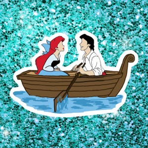 May include: A sticker featuring a cartoon illustration of a couple in a wooden rowboat. The woman has red hair and a blue dress, while the man wears a white shirt. They are on a blue water background, with a glittery teal background.