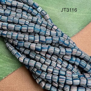May include: Strands of blue, white, and red striped beads. The beads are cylindrical and appear to be made of glass or a similar material. The text "JT3116" is visible in the upper right corner.