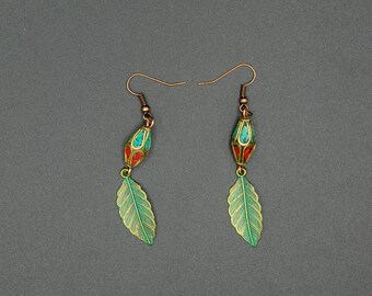 May include: A pair of dangle earrings with green and red enamel leaves and turquoise and red beads.