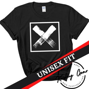 May include: Black t-shirt with a white X in a square on the front. The shirt has a unisex fit and the text "UNISEX FIT" is printed on the bottom of the shirt.