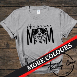 May include: Grey t-shirt with black text that says "Aussie Mom" and a black and white illustration of an Australian Shepherd dog.