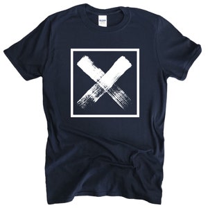 May include: A navy blue t-shirt with a white, brushstroke X inside a white square.