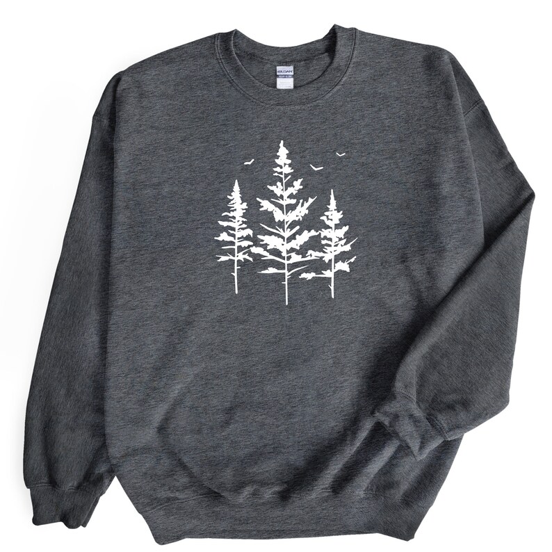 May include: A dark grey sweatshirt featuring a white silhouette of three pine trees with birds flying above them.
