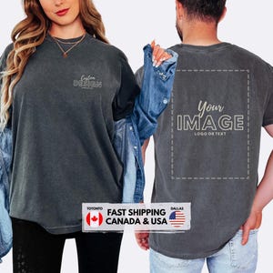 May include: Two charcoal grey t-shirts, one with "Custom Design" and the other with "Your Image" printed on them. The shirts are worn by two people. A denim jacket is draped over the shoulder of one person. The shirts have a vintage, washed appearance.