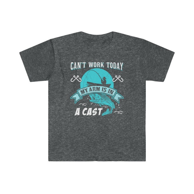 May include: Dark heather grey t-shirt with a fishing themed graphic. The graphic features a blue fish, a fishing rod, and the text "Can't work today, my arm is in a cast".