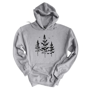 May include: A gray hooded sweatshirt with a black silhouette of three pine trees and birds flying above them.