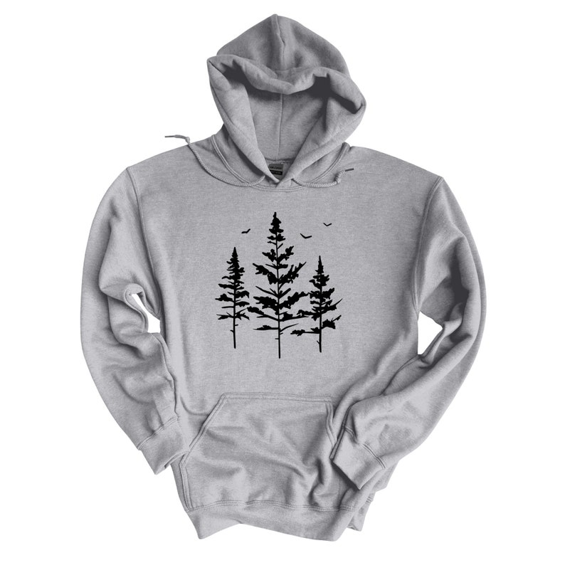 May include: A gray hooded sweatshirt with a black silhouette of three pine trees and birds flying above them.