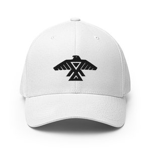 May include: White baseball cap with a black embroidered eagle design. The eagle is stylized and has a geometric pattern.