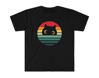 May include: Black t-shirt with a retro-style graphic of a black cat peeking out from behind a colorful sunset.