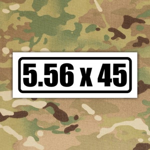 May include: White sticker with a black border and black text that reads "5.56 x 45".