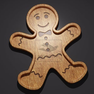 May include: A wooden gingerbread man shaped serving tray with a smiling face and a bow tie. The tray is made of light brown wood and has a natural wood finish.