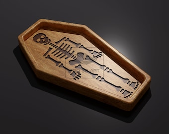 Könnte beinhalten: Ein Holztablett in Sargform mit einem ausgeschnittenen Skelettdesign. Das Tablett ist aus dunkelbraunem Holz gefertigt und hat eine glatte Oberfläche.