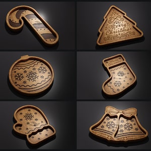 May include: Six wooden Christmas-themed serving trays with various designs, including a candy cane, a Christmas tree, a stocking, a bell, an ornament, and a mitten. Each tray features a snowflake pattern.