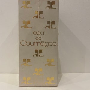 May include: A white box with gold lettering that reads "eau de Courr&egrave;ges" and features the Courr&egrave;ges logo repeated throughout the box.