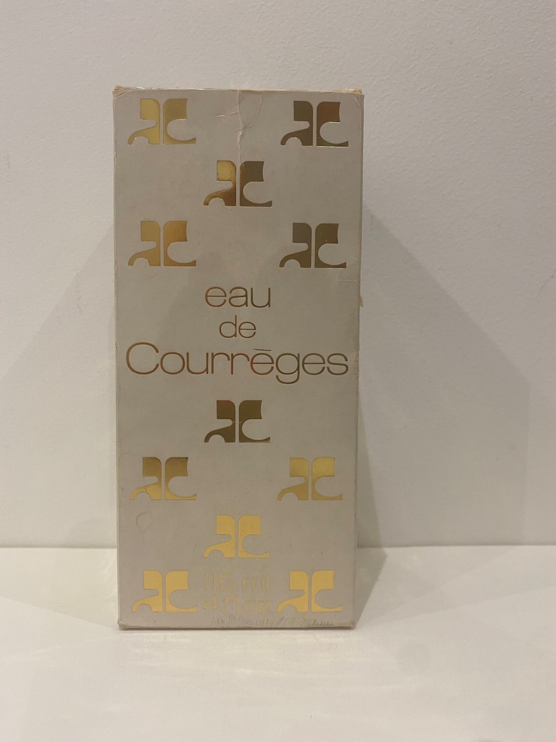 May include: A white box with gold lettering that reads "eau de Courr&egrave;ges" and features the Courr&egrave;ges logo repeated throughout the box.