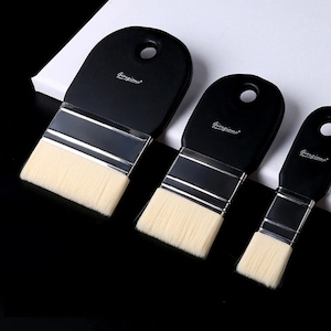 May include: Three black handled paint brushes with natural-colored bristles. The brushes are arranged in a row, decreasing in size. Each brush has a silver metal ferrule and the word "Giorgione" printed on the handle.