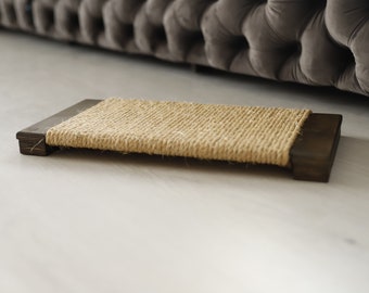 May include: A brown wooden cat scratching post with a natural sisal rope surface.