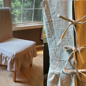 May include: A beige chair cover with a ruffled bottom and a tie closure in the back. The cover is made of a linen-like fabric.