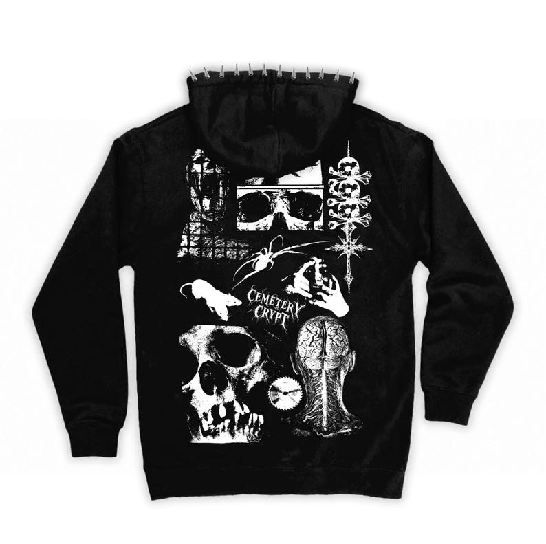 May include: A black hooded sweatshirt featuring a white graphic print on the back. The design includes skulls, a rat, a spider, a brain, and the text Cemetery Crypt. The hood edge is lined with a row of small, silver-colored metal spikes.
