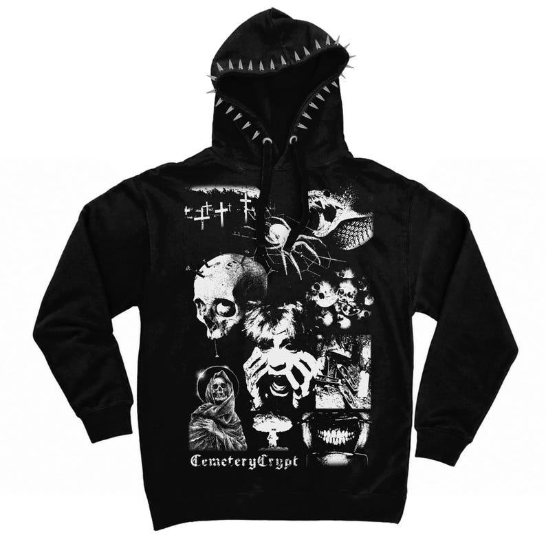 May include: A black hooded sweatshirt featuring a hood lined with silver spikes and black drawstrings. The front displays a white graphic collage of a skull, a spider, a cloaked figure, a screaming face, and the text CemeteryCrypt.
