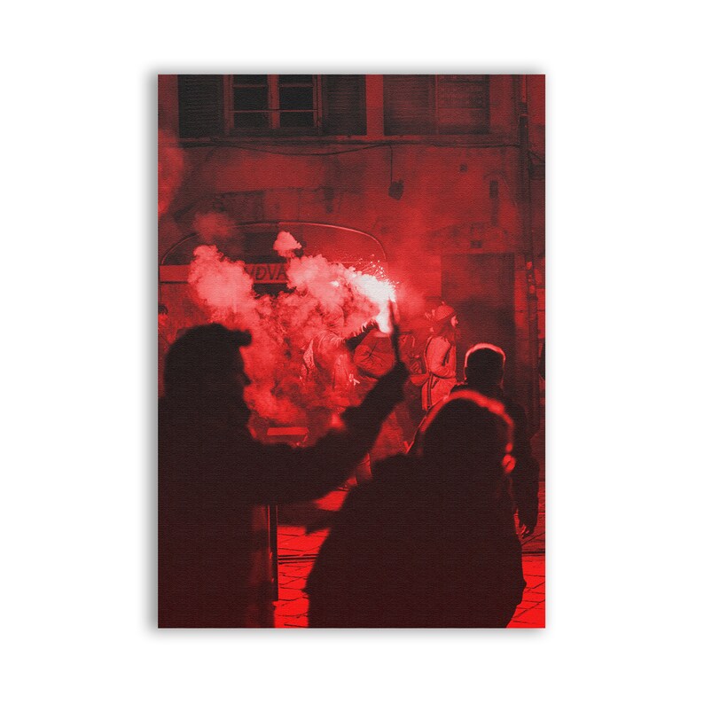 May include: A group of people in silhouette, holding red flares in a dark, red-lit alleyway. The flares create smoke and light up the scene.