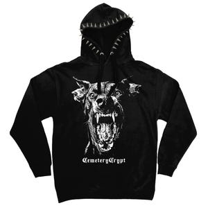 May include: Black hoodie featuring a snarling dog graphic in white, with the text "Cemetery Crypt" below the image. The hood is adorned with silver spikes.