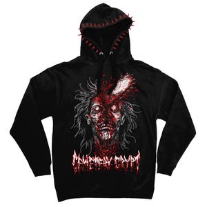 May include: A black hooded sweatshirt featuring a graphic of a disheveled figure with a blade embedded in its head. The design includes red blood splatters and the text "CEMETERY CRYPT" in a jagged font. The hood edge is lined with red spikes.