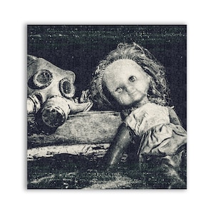 May include: A vintage porcelain doll wearing a distressed white dress and a gas mask. The doll is sitting on a wooden surface against a dark background.