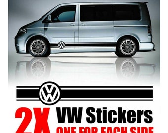 May include: Two black and white VW car stickers with a VW logo and two black stripes. The text "2X VW Stickers ONE FOR EACH SIDE" is in red letters.