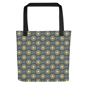 May include: Grey tote bag featuring a repeating pattern of yellow starbursts and blue tally marks. The bag has black handles and is designed for carrying items. The pattern covers the entire surface of the bag.