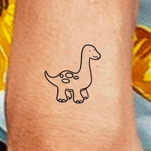 Outline Dinosaur Tattoo On Inner Lip