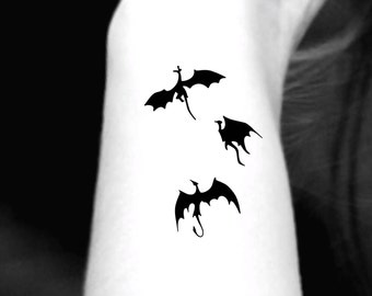 Three Little Black Dragons Tattoo Idea