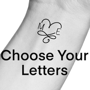 May include: A black and white image of a heart-shaped design with the letters "M" and "E" inside. The text "Choose Your Letters" is below the design.