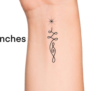 May include: A temporary tattoo with a black line design of a star and a swirling pattern. The tattoo is 2 inches tall.
