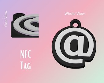 May include: A black and white at symbol keychain with an NFC tag. The keychain is round and has a silver at symbol on a black background. The keychain is shown from the side and the front.