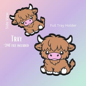 May include: Two cartoon images of a Highland cow, one from the side and one head-on. The cows are brown with white horns and feet, a pink nose, and a black outline. The text "Tray" and "*3MF FILE INCLUDED" are visible.