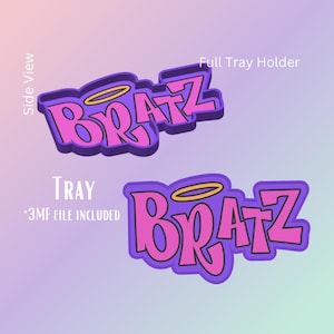 May include: Two views of a purple and pink "Bratz" logo with a gold halo. The text "Full Tray Holder" and "Tray *3MF FILE INCLUDED" are also visible. The design is set against a gradient background.