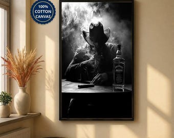 May include: A framed black and white wall art print featuring a person wearing a cowboy hat, sitting at a table with a cigar and a bottle of Jack Daniel's whiskey, surrounded by smoke. A blue circular badge reads 100% COTTON CANVAS.
