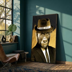 May include: A framed art print featuring a gorilla in a suit and fedora hat. The artwork has a gold and black background with a textured appearance. The gorilla's face is detailed, and the overall style is a blend of realism and artistic flair.