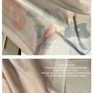 May include: A white backdrop with a colourful abstract pattern. The backdrop is made of thin polyester and is see-through. The text on the backdrop reads "COVID HOME FOR HOLIDAYS * 100% polyester * the latest printing techniques provide bright and crisp colours *please note it's a thin polyester material and it is see through as in attached image"