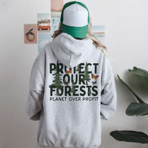 May include: Gray hooded sweatshirt with a green print that says "Protect Our Forests" and "Planet Over Profit". The print also features a group of trees and butterflies.