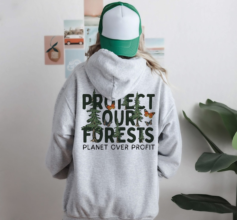 May include: Gray hooded sweatshirt with a green print that says "Protect Our Forests" and "Planet Over Profit". The print also features a group of trees and butterflies.