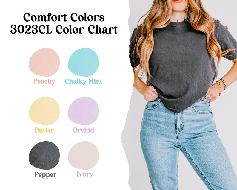 May include: A woman wearing a dark gray t-shirt and light blue jeans. The image includes a color chart with the text "Comfort Colors 3023CL Color Chart" and color swatches labeled Peachy, Chalky Mint, Butter, Orchid, Pepper, and Ivory.