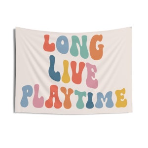 May include: A tapestry featuring the text "Long Live Playtime" in colourful, wavy letters. The letters are in shades of blue, green, yellow, orange, pink, and red.