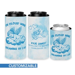 May include: A blue and white can cooler with a sleeping cherub design and the text "On Cloud Nine Dreaming of I Do". The cooler is customizable with a name and event details.