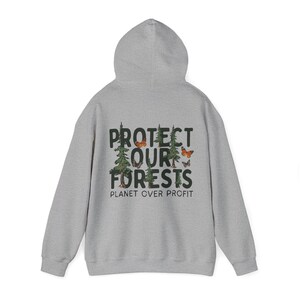 May include: A gray hooded sweatshirt with the text "PROTECT OUR FORESTS PLANET OVER PROFIT" printed on the back. The text is in black with a green tree and orange butterfly graphic.