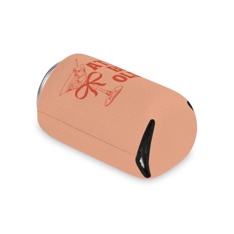 May include: A peach-colored can cooler with a black zipper. The cooler has a red graphic of a martini glass with an olive and a red ribbon. The text on the cooler reads "41 &  Old".