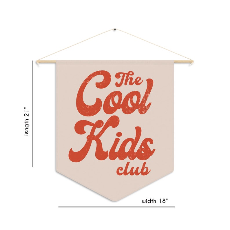 May include: A beige fabric banner with a red vintage-style font that reads "The Cool Kids Club". The banner is 21 inches long and 18 inches wide.